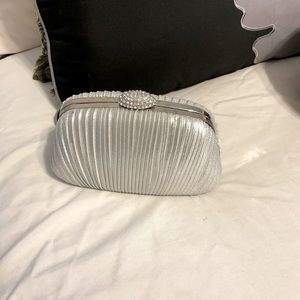 Silver clutch bag. Has a chain also